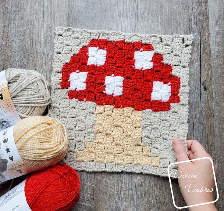 a crocheted mushroom is on the floor next to yarn