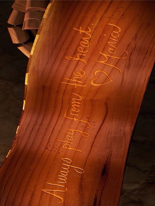 a piece of wood with writing on it