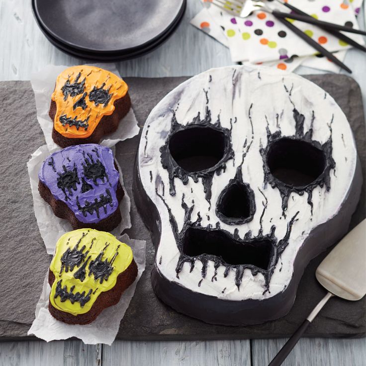 there is a cake decorated to look like a skull and three other items on the table