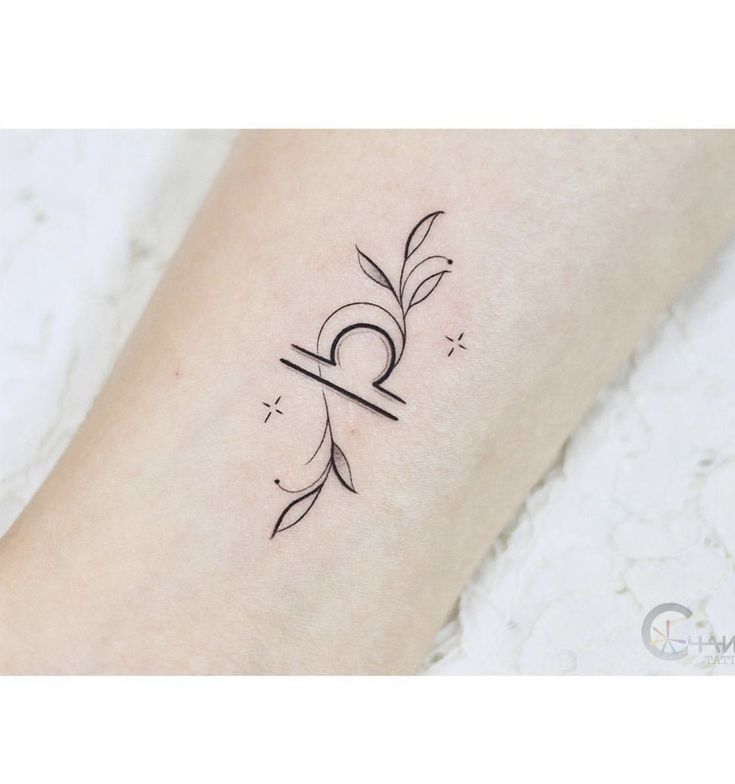 a woman's foot with a small tattoo on her left leg and the word love written