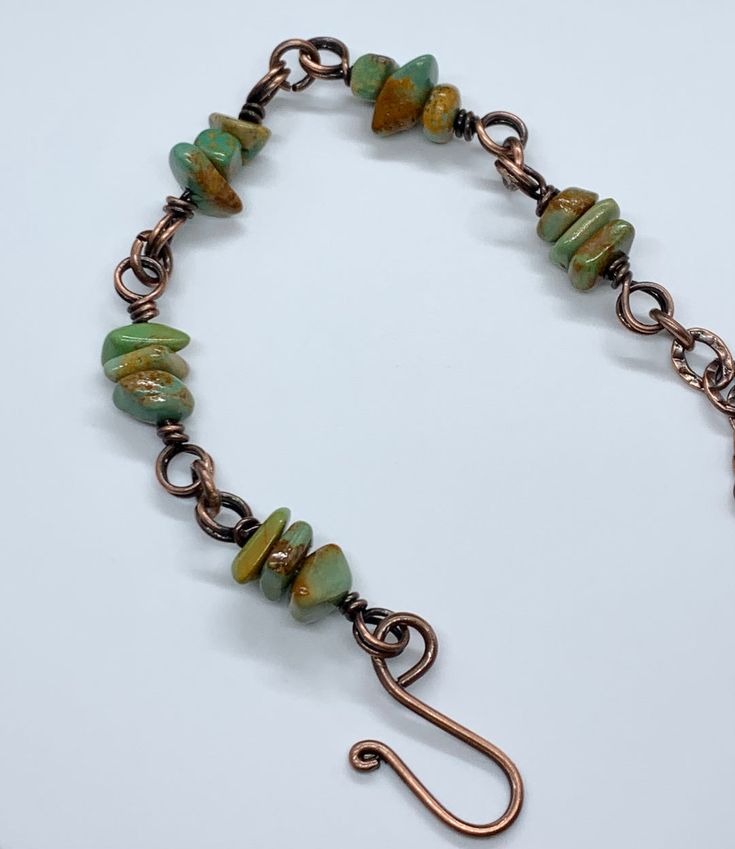 Adjustable Kingman Turquoise Chips Bracelet in Copper. The Kingman Turquoise Mine is one of the oldest and highest producing Turquoise Mines in America. It was originally discovered by prehistoric Indians well over 1000 years ago. The Kingman Turquoise mine also produces green Turquoise from the Turquoise Mountain side Adjustable Turquoise Nature-inspired Jewelry, Green Bohemian Bracelets With Patina, Adjustable Chrysoprase Jewelry For Healing, Earthy Turquoise Jewelry For Healing, Rustic Green Adjustable Jewelry, Rustic Turquoise Beaded Bracelets With Natural Stones, Earthy Turquoise Bracelet Jewelry, Adjustable Turquoise Bracelet With Patina, Adjustable Turquoise Bracelets With Patina