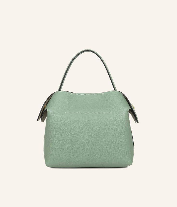 The Almond Green, soft and poetic, is perfect for accompanying your everyday outfit or for accentuating a more formal look. This high-quality grained leather handbag, crafted in our Italian workshop, is as practical as it is aesthetic, with ample space to hold your essentials, a good book, and your sunglasses. Elegant Green Hobo Bag With Double Handle, Green Top Handle Bucket Bag For Formal Occasions, Elegant Green Satchel Hobo Bag, Green Workwear Bag With Detachable Handle, Elegant Green Top Handle Bucket Bag, Green Formal Bucket Bag With Detachable Handle, Formal Green Bucket Bag With Removable Pouch, Solid Color Top Handle Bucket Bag, Elegant Green Tote Bucket Bag