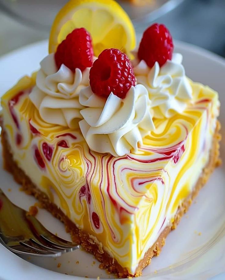 a slice of lemon raspberry swirl cheesecake on a plate with a fork