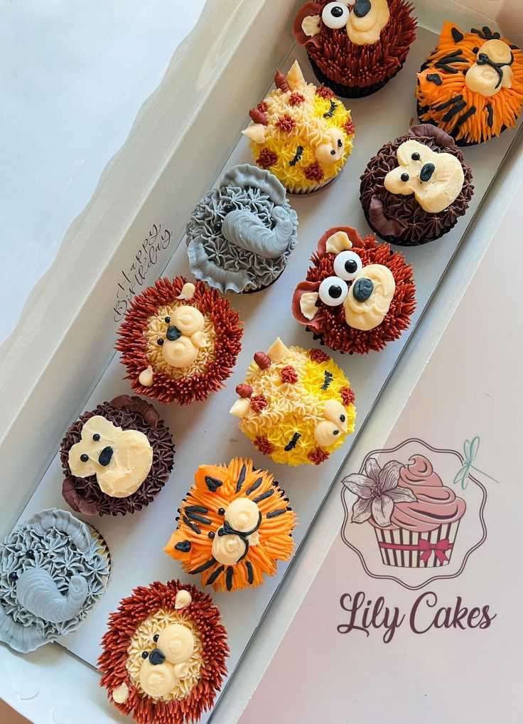 cupcakes decorated like animals and lions in a box