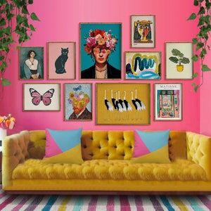 a living room with pink walls and pictures on the wall, including a yellow couch