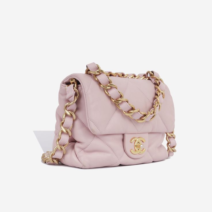 This is a unique seasonal piece takes inspiration from the Chanel 19 bag, replicating the soft supple shape and large diamond quilting, yet with a traditional CC closure. Crafted in goatskin leather and an enlarged chain/leather strap, this little bag is compact and classic. SPL Exterior Baby pink goatskin leather Champagne gold hardware Chunky chain/leather top handle Chunky chain/leather shoulder strap CC twist closure Plaque series Good condition - visible rubbing/darkening to the corners and flap corners. Tarnishing to the closure hardware. Interior Pink fabric interior Two compartments Chanel embossed logo One zip pocket Great condition - some light marks inside and under the flap Sold with box and dustbag SPL Height 16cm Width 20cm Depth 6cm Chic Top Handle Bag With Diamond Quilting, Elegant Pink Quilted Shoulder Bag, Chic Everyday Luxury Shoulder Bag With Diamond Quilting, Chic Diamond-quilted Shoulder Bag For Everyday Luxury, Pink Quilted Leather Bag, Champagne Gold Hardware, Chanel 19 Bag, Chanel 19, Timeless Handbag