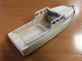 a model boat sitting on top of a wooden table