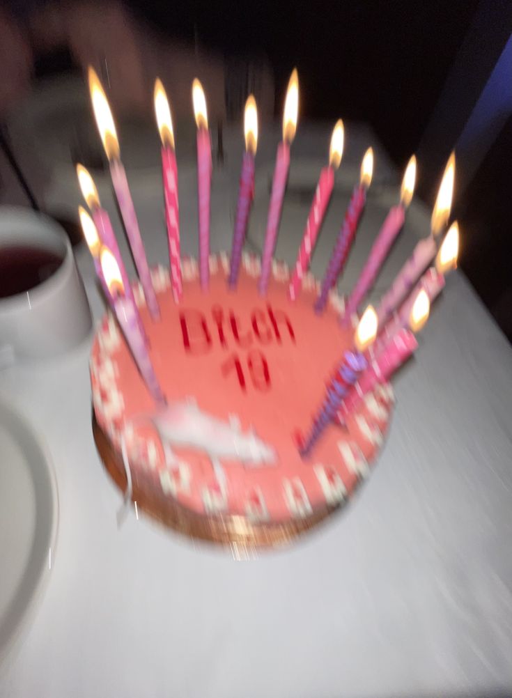 a birthday cake with lit candles on it