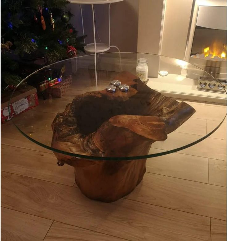 a glass table that has a wooden log on it