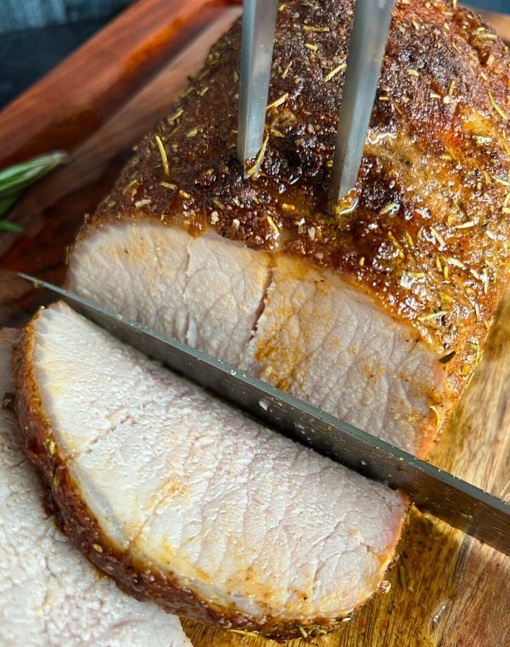 the meat is being cut into pieces on the cutting board