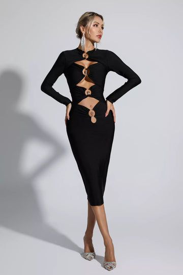 a woman wearing a black dress with cut outs on the sides and long sleeves, in front of a white background