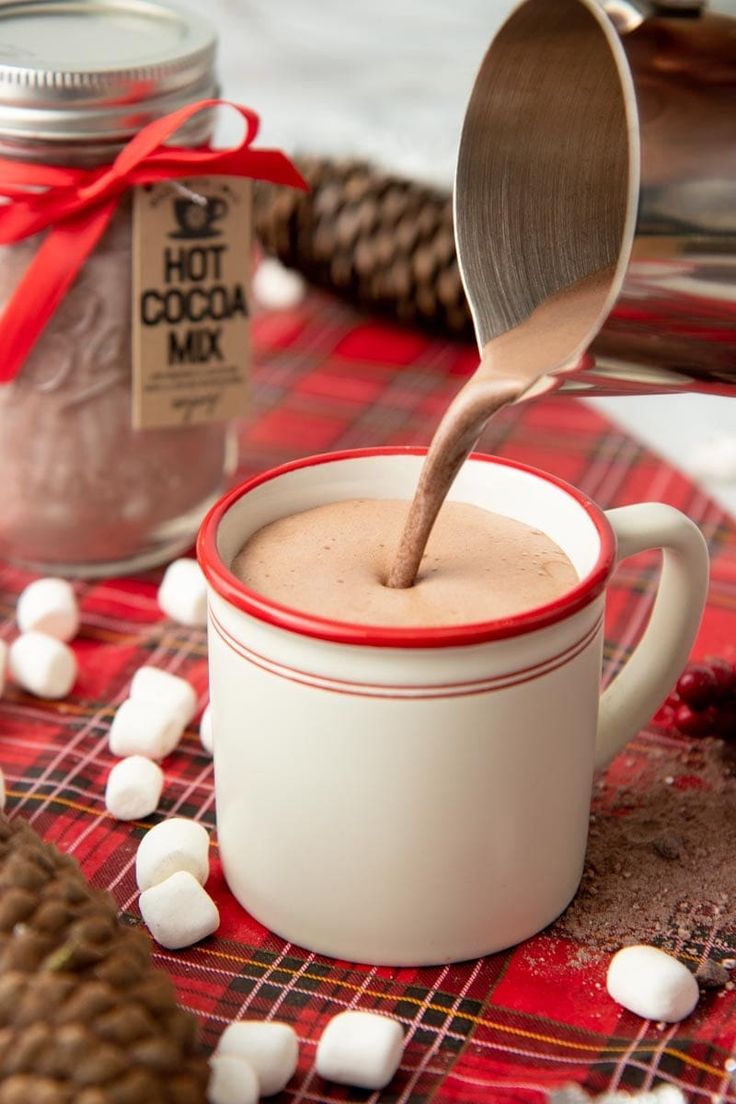 hot cocoa in a mug with marshmallows on the table