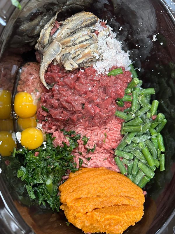 an assortment of meats and vegetables in a bowl