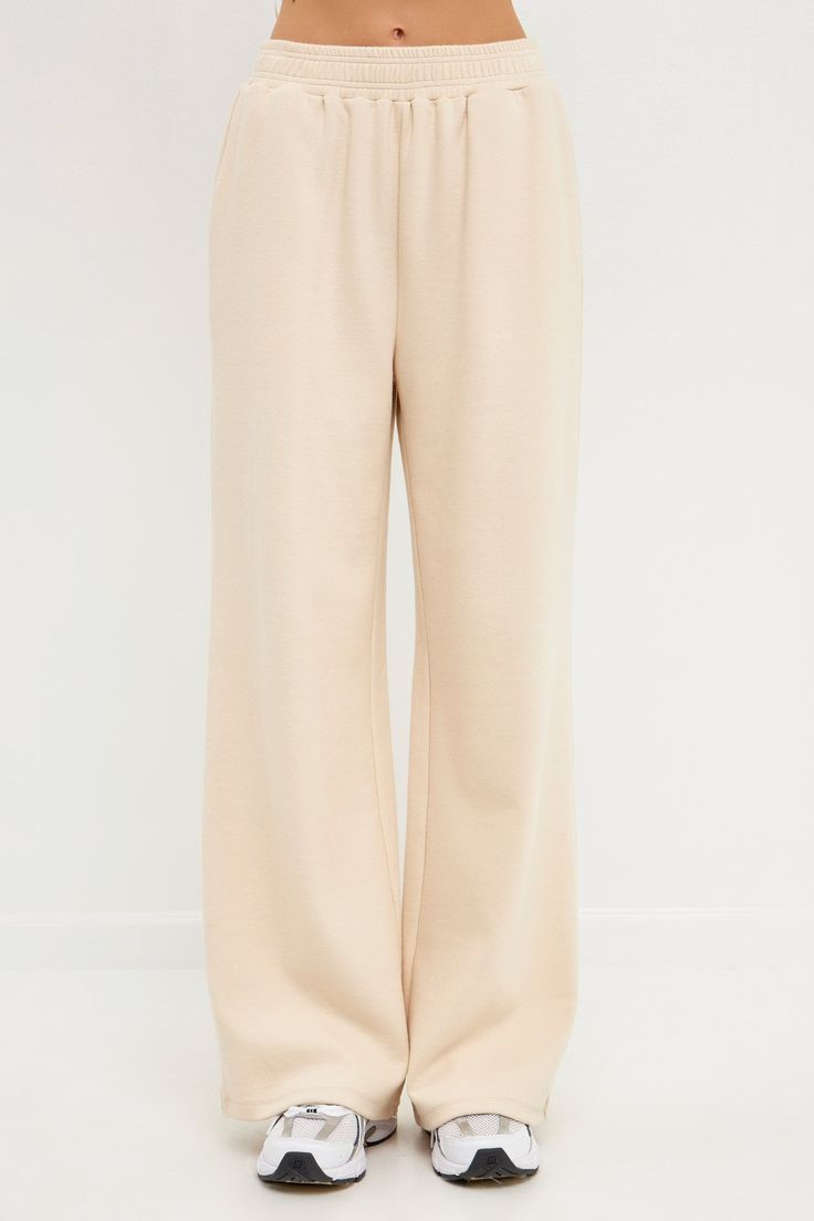 Step up your lounge game with our chic wide knit pants. These pants are sure to become your new favorite, whether you're relaxing at home or running errands. The wide leg and knit fabric give them a stylish look, while the beige cream hue makes them easy to pair with any top. Plus, they're so comfortable you'll never want to take them off! Wide pants Knit Elastic at waist Shell: 55% Cotton 43% Polyester 2% Spandex JJ941P XS Height 5'9" / (175cm) / Bust 34" / (86cm) / Waist 26â€(67cm) / Hip 35â€ Chic Beige Sweatpants For Loungewear, Chic Beige Relaxed Fit Sweatpants, Beige Relaxed Fit Bottoms For Lounging, Relaxed Fit Beige Bottoms For Lounging, Beige Wide Leg Relaxed Fit Sweatpants, Beige Wide-leg Relaxed Fit Sweatpants, Beige Relaxed Fit Wide Leg Sweatpants, Beige Full Length Sweatpants With Elastic Waistband, Beige Straight Leg Sweatpants With Elastic Waistband