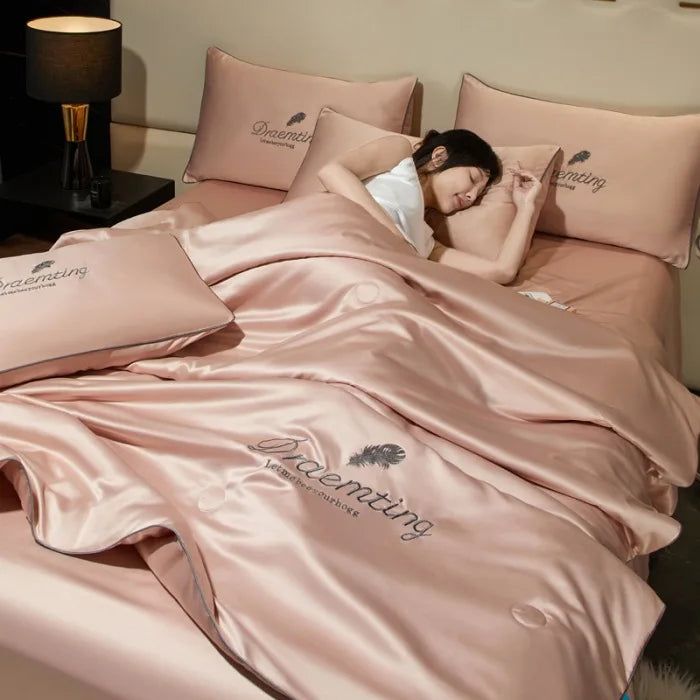 a woman laying in bed with pink sheets and pillows on top of her head, next to a night stand