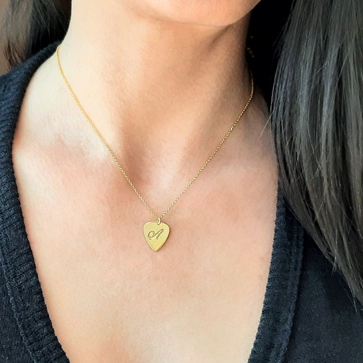 This is the piece of jewelry to get for every Rock lover. This Guitar pick necklace the perfect gift for guitarists ,music lovers, and for every musician. The necklace is totally handmade the base material is 14k or 9k Solid Gold,White or Rose gold Metal information and dimensions details: ---------------- Width : 17.00mm x 14.50mm Metal: Solid 9K Yellow ,White or Rose gold or Solid 14K Yellow ,White or Rose gold Solid gold chain 9k Yellow,White or Rose gold or Solid gold chain 14k Yellow,White Adjustable Engraved Heart Necklace Gift, Engraved Adjustable Heart Necklace Gift, Heart-shaped Music-themed Jewelry Gift, Music-themed Heart-shaped Jewelry Gift, Personalized Gold Music-themed Jewelry, Music-themed Pendant Necklaces As Gift, Nickel-free Music-themed Jewelry As Gift, Music-themed Pendant Necklace As Gift, Music-themed Pendant Jewelry For Gifts