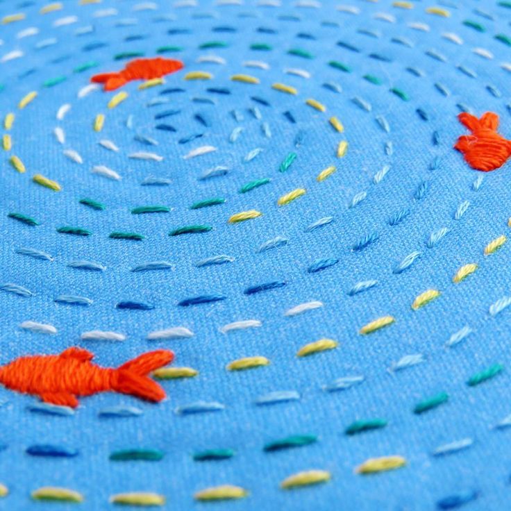 two goldfishs are swimming in the water on a blue surface with white dots