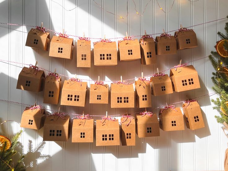 several cardboard houses are hanging on a string