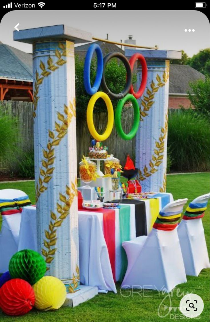 an outdoor party with colorful decorations and balloons