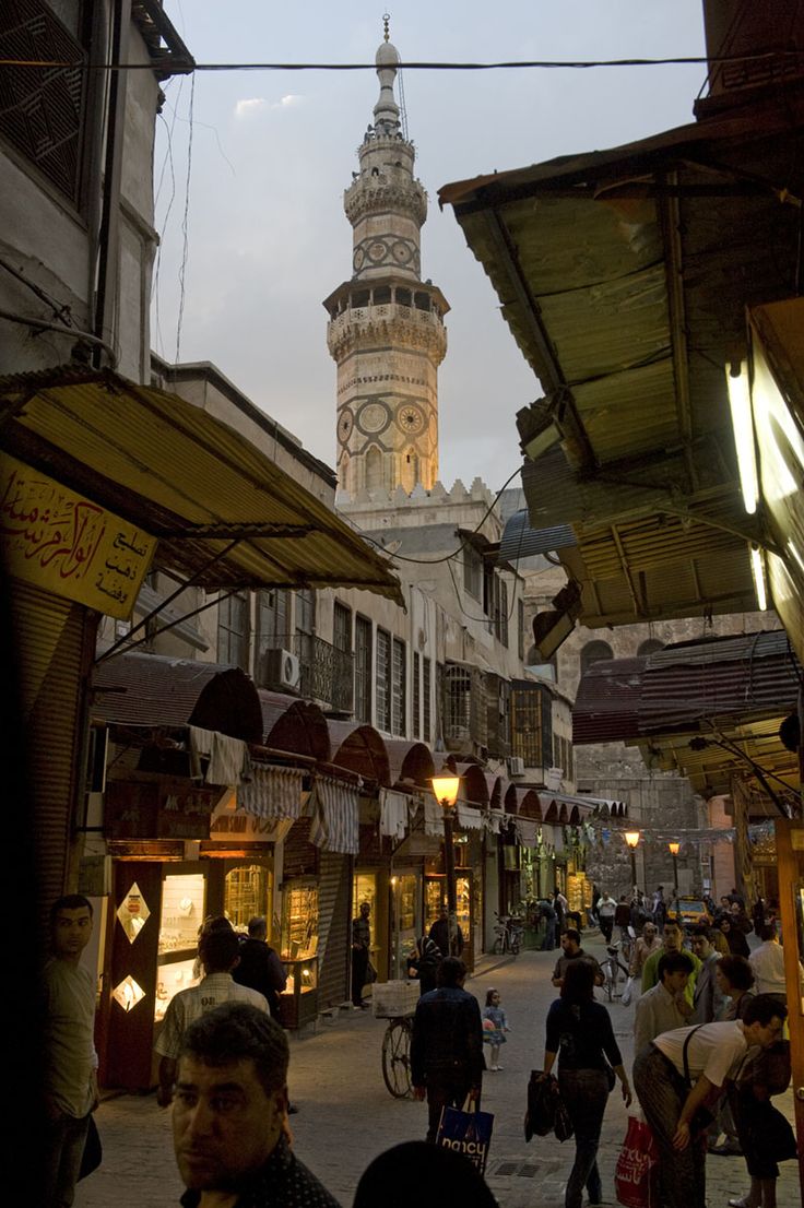 people are walking around in an outdoor market