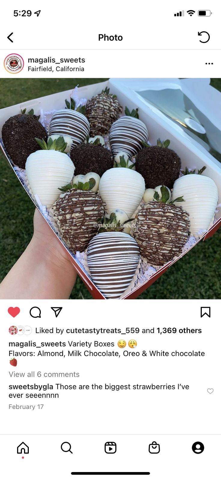 chocolate covered strawberries are arranged in a heart shaped box