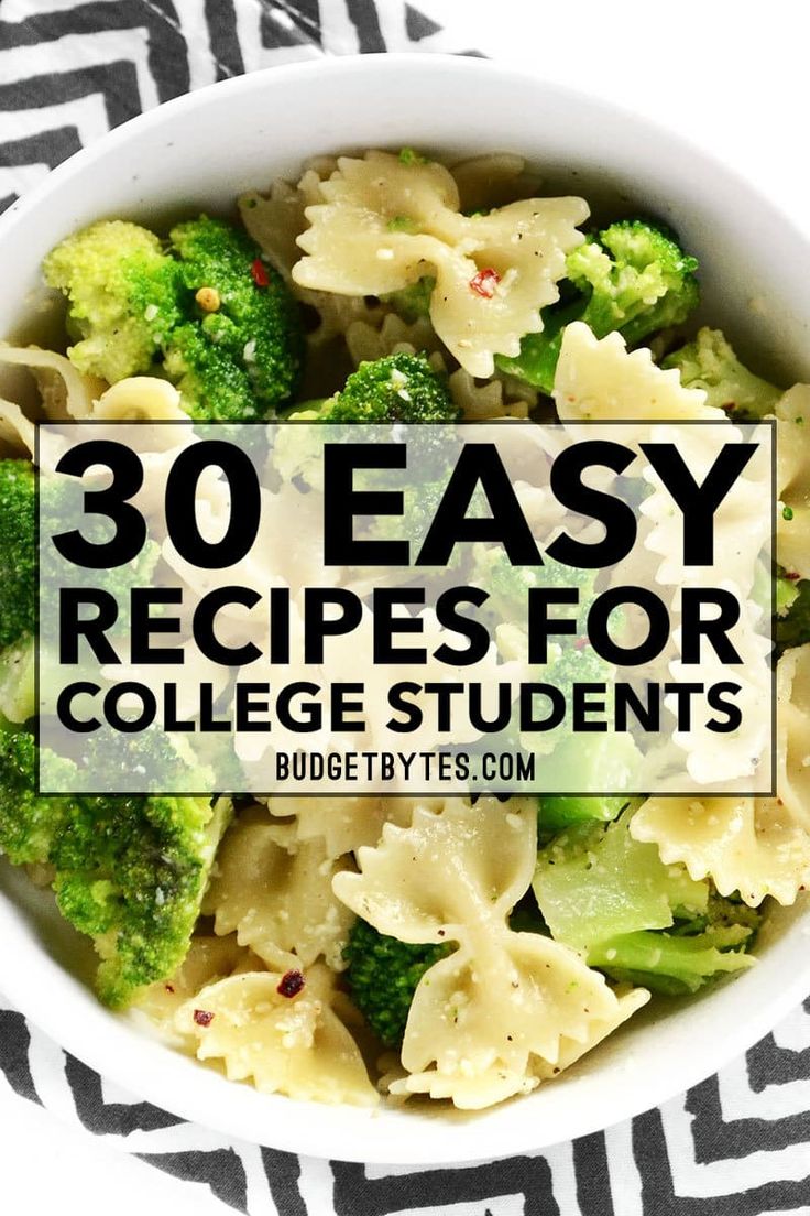 a bowl filled with pasta and broccoli on top of a zebra print table cloth