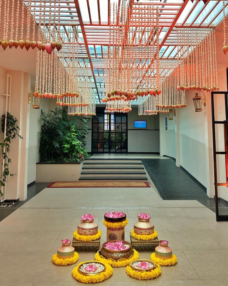 the entrance to a building decorated with flowers and chandelier hanging from the ceiling