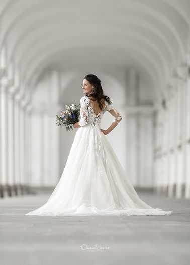 a woman in a white wedding dress holding a bouquet