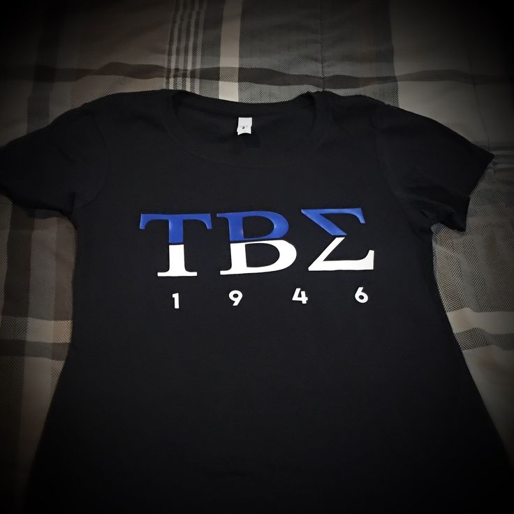 Tau Beta Sigma Active T-shirt. T-shirt is made of 50% cotton / 50% poly (50/50 Blend). T-shirt's are DryBlend™ fabric helps to wick moisture away from the body. ----------------------------------------------------------------------------- Shirt Type -Unisex Style are a standard fit. For women, that means it runs big. -Women style shirts are fitted. Black Fan Merchandise T-shirt With Branding, Black Branded T-shirt For Fan Merchandise, Fitted Short Sleeve T-shirt For Fan Merchandise, Fitted Tan T-shirt With Letter Print, Fitted Black T-shirt With Branding, Black Fitted T-shirt With Branding, Pre-shrunk Short Sleeve Tan T-shirt, Pre-shrunk Tan Short Sleeve T-shirt, Fitted Tan T-shirt With Graphic Print