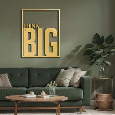 a living room filled with furniture and a large painting on the wall above it that says think big