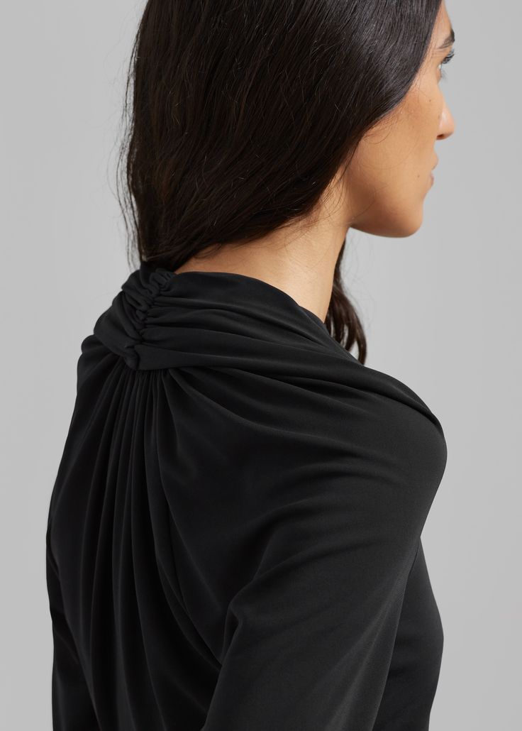 Color: Black Mid weight knit fabric with stretch Slim fit High v-neckline Gathered drape detail at back neckline Ruched drape shoulder detail Slip on style Double lined front panel 72% Viscose 28% Polyester Cold Hand Wash By Esse Studios. Made in Australia Black Fitted Top With Cowl Back, Black Ruched Top For Formal Occasions, Elegant Stretch Top With Cowl Back, Black Cowl Neck Top For Evening, Elegant Tops With Ruched Back For Night Out, Elegant Tops For Night Out With Ruched Back, Elegant Black Ruched Tops, Esse Studios, V Top