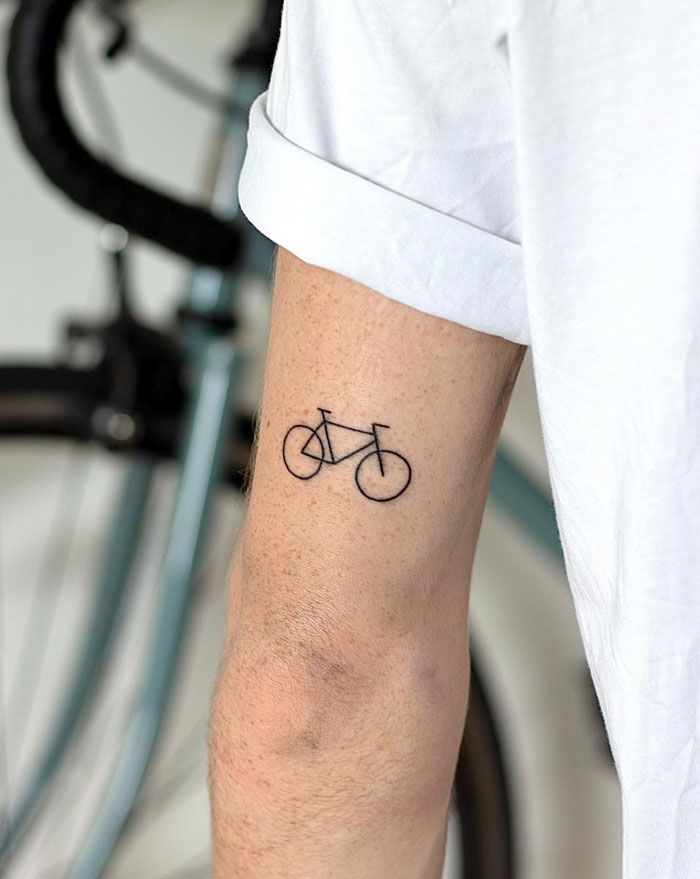 a man with a bicycle tattoo on his arm