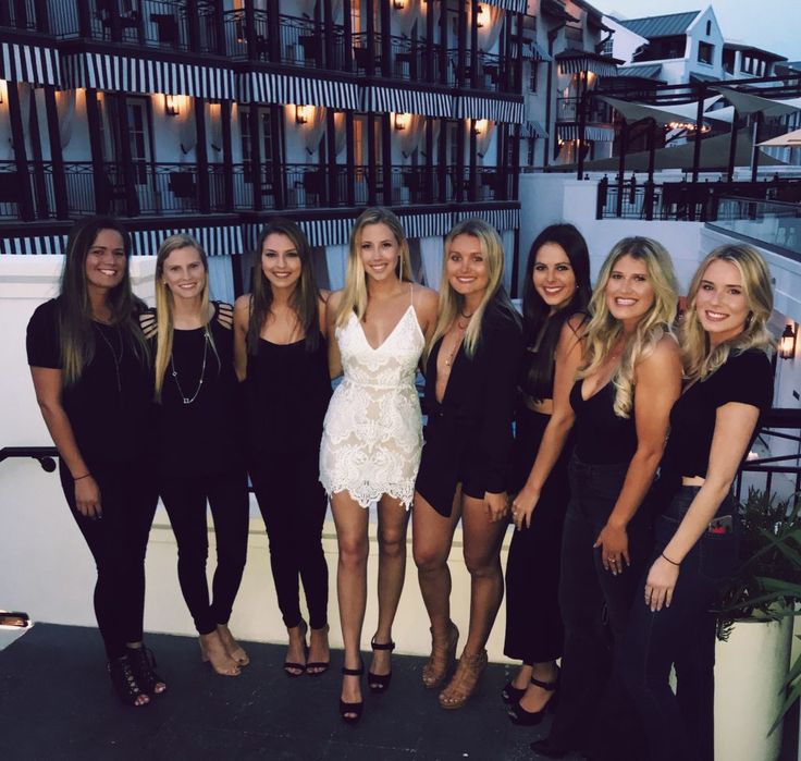 a group of beautiful women standing next to each other