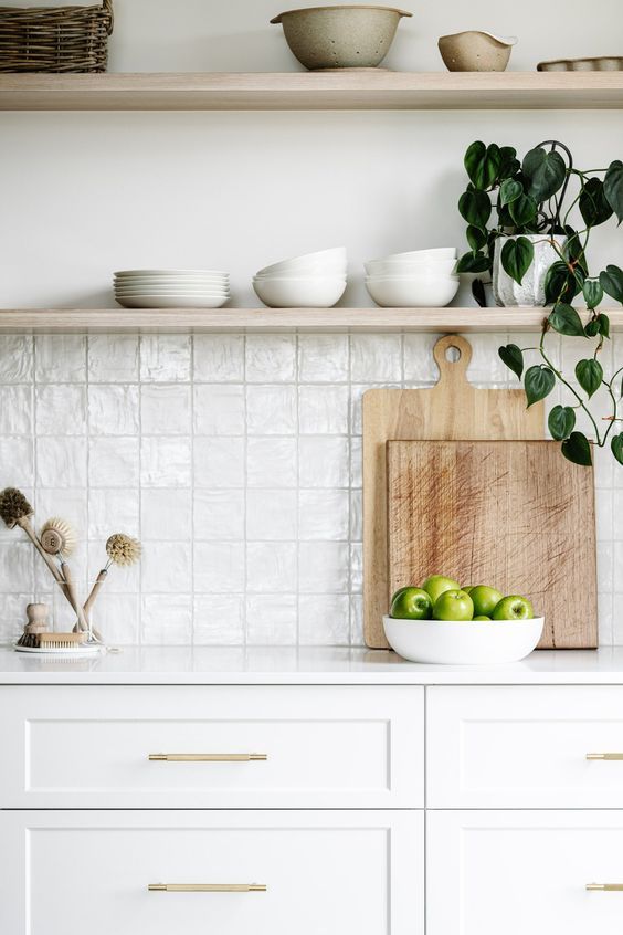 the kitchen counter is clean and ready to be used as a place for some green apples