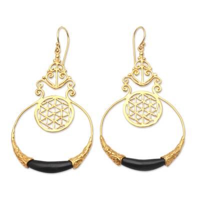 A tiny openwork circle hangs within a delicately crafted golden hoop in this exquisite pair of earrings from Made Nuada. Hand crafted from 18k gold-plated brass the earrings feature curling golden designs and a small but striking water buffalo horn accent at the bottom of the hoop. Golden Hoops, Golden Design, Water Buffalo, Henna Tattoo Designs, Bead Earrings, Henna Tattoo, Beaded Earrings, Horn, Henna