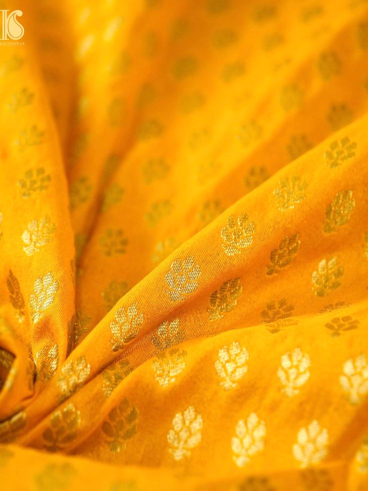 the fabric is yellow with white flowers on it