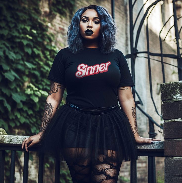 "Indulge in the wickedly delightful irony with our \"Sinner\" vintage devilish tee. Picture this: a Barbie doll, the epitome of innocence, reimagined with a devilish twist. It's a playful and humorous contrast that adds a touch of rebellious charm to your wardrobe. Crafted with a rebellious spirit and a nod to vintage aesthetics, this shirt isn't just about making a statement; it's about rewriting the rules of fashion. The comfortable Airlume combed and ringspun cotton ensures a soft touch against your skin, providing both comfort and style in one devilishly delightful package. Embrace the darker elements with a tee that exudes confidence and attitude. The unisex fit guarantees a versatile wardrobe piece that anyone can rock with flair. Make a bold statement that echoes your rebellious spi Goth Barbie Aesthetic, Sinner Shirt, Satanic Shirt, 2010s Fashion, Lover Clothes, Vintage Aesthetics, Gothic Clothes, Versatile Wardrobe, The Rules