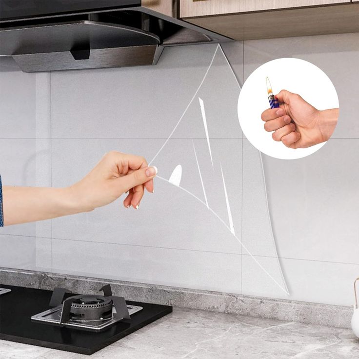 a person is holding something in their hand and pointing to it on the stove top