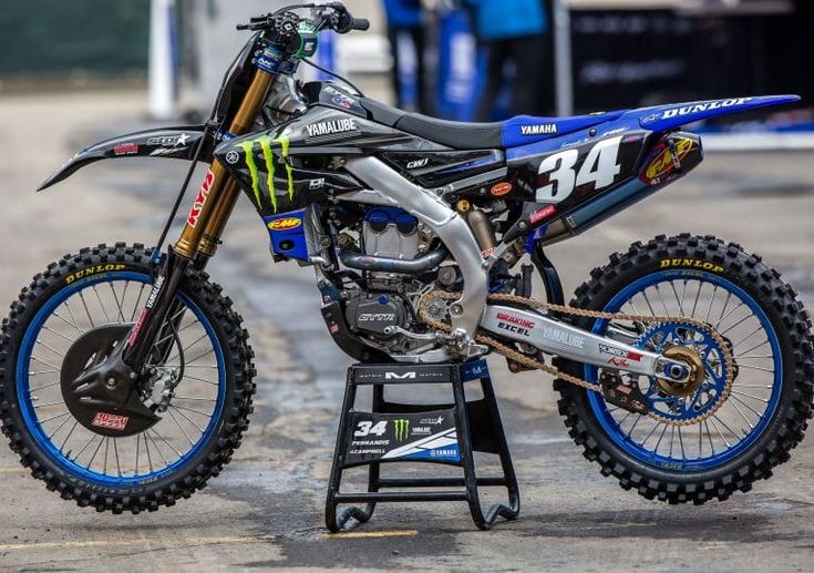 a dirt bike parked on top of a metal stand