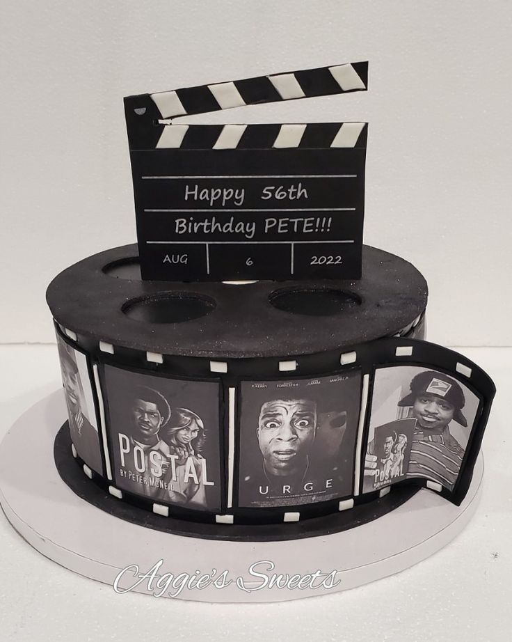 a birthday cake made to look like a movie clapper with pictures of people on it