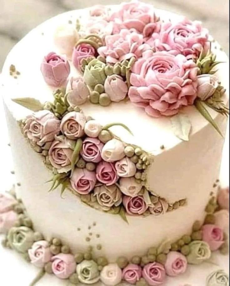 there is a white cake with pink flowers on it