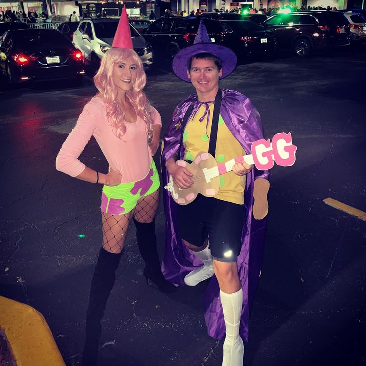 two people dressed in costumes posing for the camera