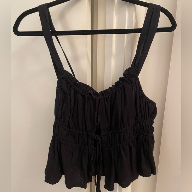 Black Camisole From Free People - No Longer Sold. Three Ties At The Front, Adjustable Ties On The Strap. Never Worn! Black Fitted Tank Top With Tie Straps, Black Cotton Top With Tie Straps, Black Cotton Tops With Tie Straps, Black Tank Camisole For Day Out, Black Sleeveless Camisole For Day Out, Black Camisole Tank Top For Day Out, Black Crop Top Camisole For Spring, Black Tank Top For Day Out, Black Cami Tank Top For Day Out