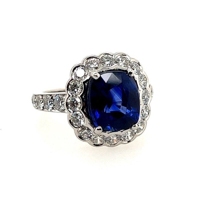 Stunning Modern Platinum Ring. The 3.15 carat centerstone is a Royal Blue Cushion Shaped heated Sri Lankan Sapphire measuring 8.64x7.53x5.24mm. The ring is set with 26 natural round brilliant D-E color, VS clarity diamonds weighing 1.14 carats. Total weight is 7.8 grams, 4.29 carats, size 4.5 Classic Sapphire Gemstones With Halo Setting, Gia Certified Sapphire Cluster Jewelry, Classic Sapphire Halo Ring With Gemstone, Blue Cluster Ring With Center Stone In Platinum, Round Sapphire Gemstone With Halo Setting, Anniversary Sapphire Gemstones With Halo Setting, Sapphire Gemstones In Prong Setting, Sapphire Gemstones With Prong Setting, Gia Certified Cluster Sapphire Ring