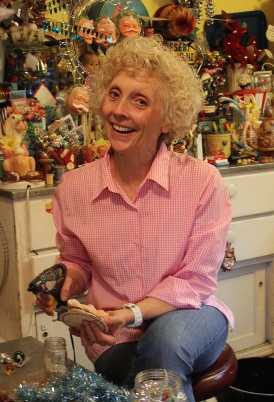 a woman sitting on top of a chair holding a bird