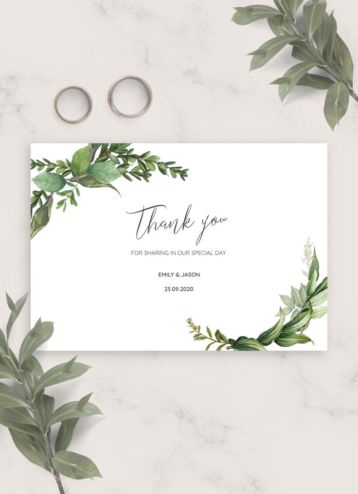 wedding thank card with greenery and rings on the side, next to some leaves