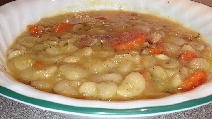 a white bowl filled with soup on top of a table