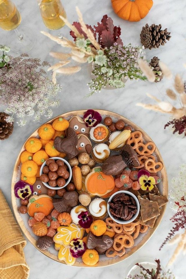 a platter filled with cookies, pretzels and candy