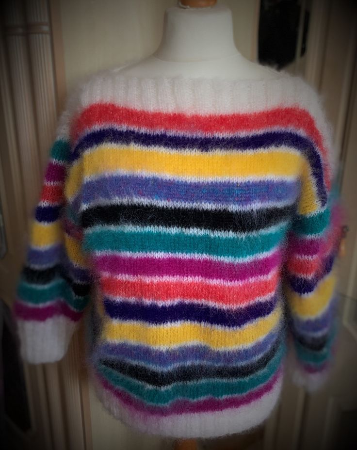 Title: Rainbow and white striped sweater Description: A perfect weekend oversized sweater, great with jeans. Casual warm snug sweater Great to be worn on its own or in layers.  The main colour is white, the stripes are of cerise, jade green, black, blue fleck, yellow, purple and orange. For interest the stripes of yellow are slightly wider. The colour way is reminiscent of the 80's.    Content: The high quality British yarn a mixture of yarns with the majority being 78 % mohair, 22 % nylon  The Winter Multicolor Striped Sweater, Trendy Horizontal Stripe Winter Sweater, Trendy Winter Sweater With Horizontal Stripes, Trendy Horizontal Stripe Sweater For Winter, White Long Sleeve Sweater With Horizontal Stripes, Oversized Winter Sweater With Contrast Stripes, Multicolor Long Sleeve Sweater With Contrast Stripes, Pantone Color Chart, White Striped Sweater