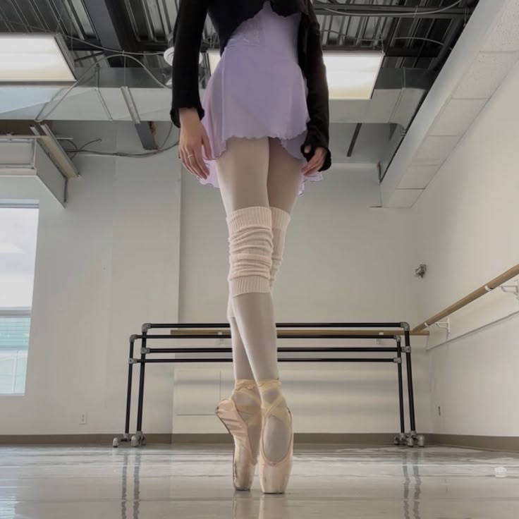 a ballerina is standing in the middle of an empty room